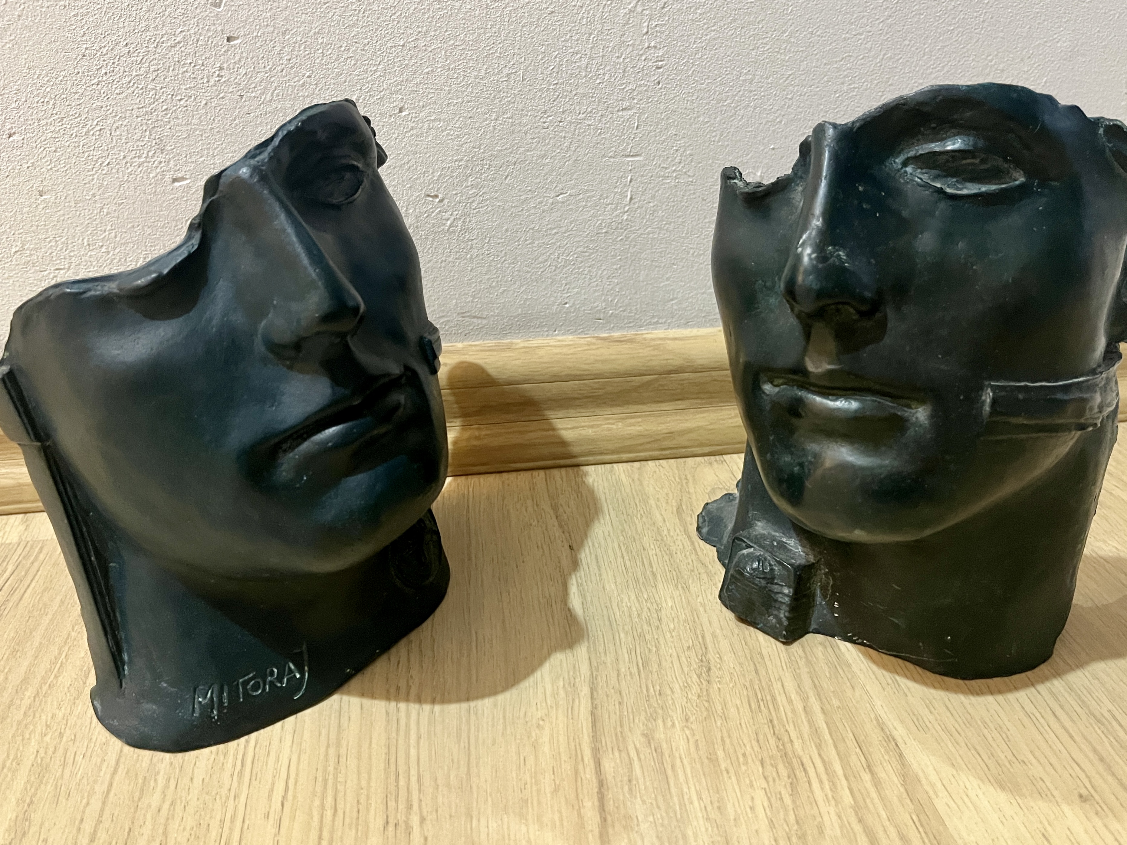 Pair of bronze faces — Igor Mitoraj