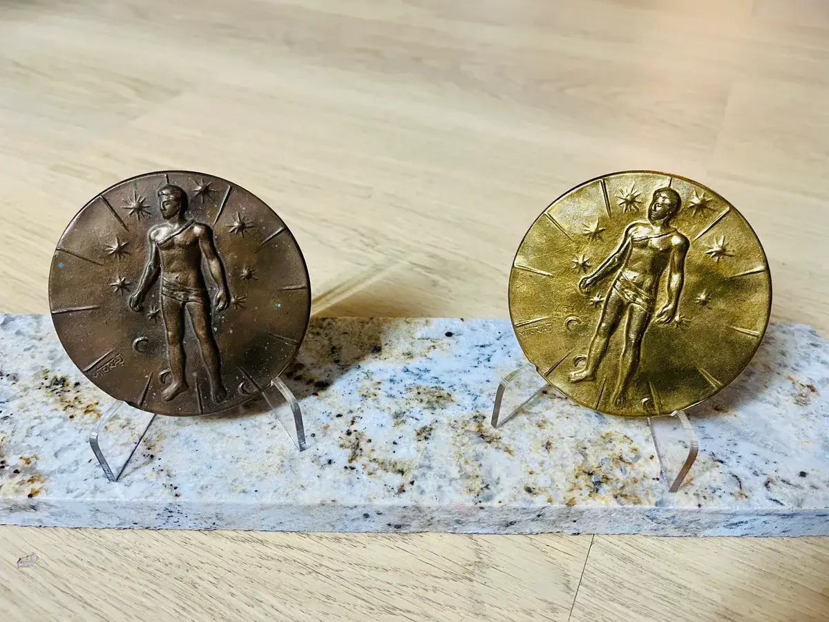 Mitoraj Articulations — both medals, dark and gilt editions