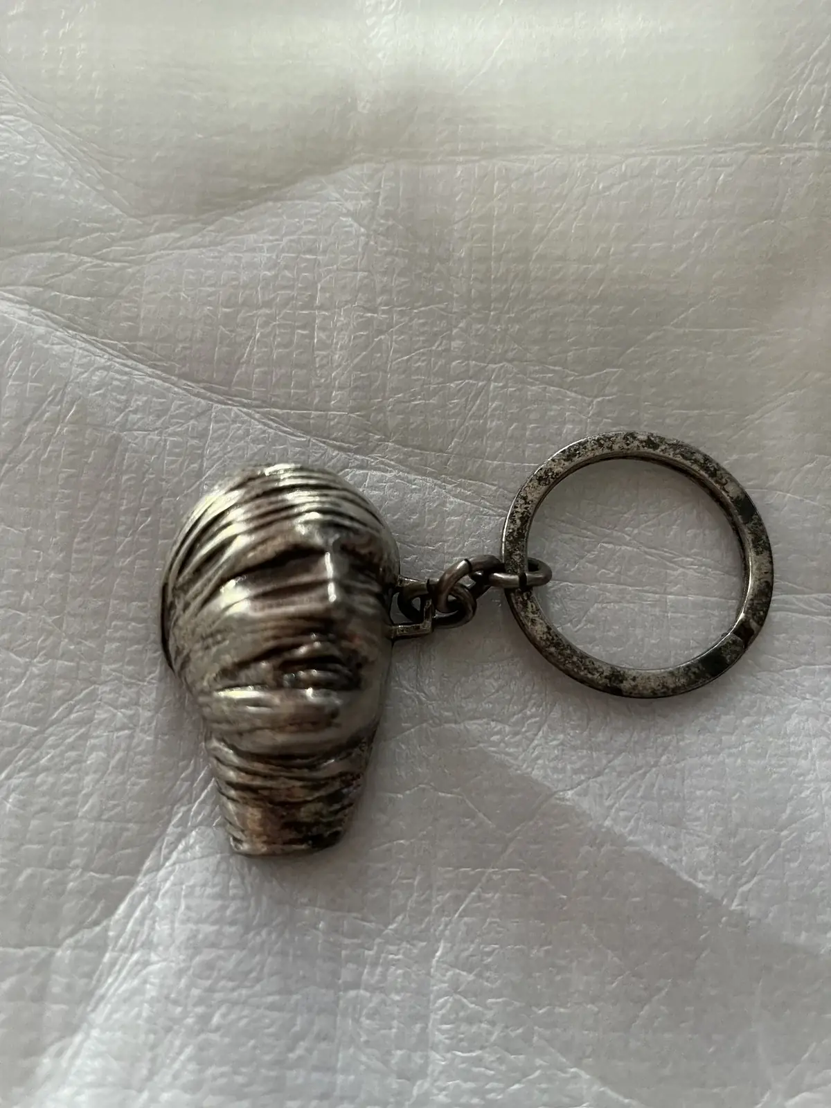 Testa Addormentata (Amnesty International) — Igor Mitoraj, silver pendant three-quarter view, private collection