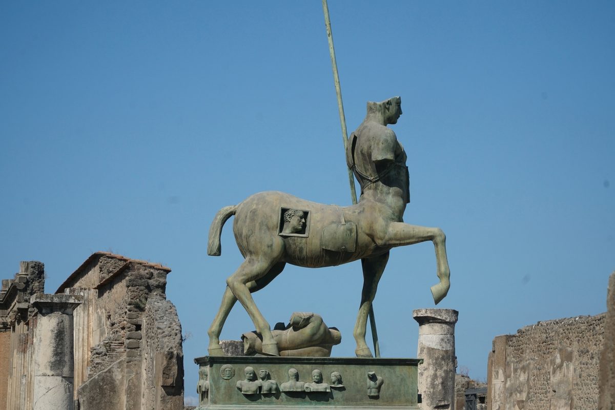 Igor Mitoraj Centauro bronze centaur sculpture among the ruins of Pompeii — permanent public collection
